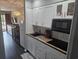 Well-equipped galley kitchen with white cabinets and wood countertops at 1100 Possum Trot Rd. # F-224, North Myrtle Beach, SC 29582