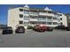 Exterior view of a multi-unit building with parking at 1100 Possum Trot Rd. # F-224, North Myrtle Beach, SC 29582
