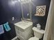 Clean bathroom with white vanity, dark walls, and a large mirror at 1100 Possum Trot Rd. # F-224, North Myrtle Beach, SC 29582