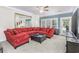Comfortable living room with a red sectional sofa, large mirror, and access to a balcony at 127 Garden City Connector # 210, Murrells Inlet, SC 29576