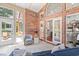 Sunroom with brick walls, windows offering backyard views, and access to other rooms at 3420 Cedar Creek Run, Little River, SC 29566