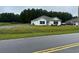 White house with teal door and a spacious yard at 1884 Mount Zion Rd., Loris, SC 29569