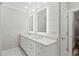 Elegant bathroom with double vanity, marble tile, and lighted mirrors at 1612 16Th Ave., Conway, SC 29526