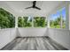 Spacious porch with wood-look flooring and views of the lush trees at 1612 16Th Ave., Conway, SC 29526