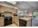 Open kitchen with breakfast bar, stainless steel appliances and light wood cabinets at 4103 Pinehurst Circle # Bb-11, Little River, SC 29566