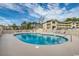 Kidney shaped community pool with lounge chairs at 4103 Pinehurst Circle # Bb-11, Little River, SC 29566