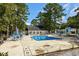 Community pool with surrounding patio and shuffleboard at 251 Galapagos Dr., Little River, SC 29566