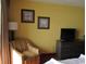 Comfortable armchair, dresser, and wall-mounted TV at 1501 S Ocean Blvd. # 429, Myrtle Beach, SC 29577