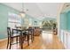 Spacious living room with hardwood floors, large windows, and access to balcony at 624 River Oaks Dr. # 52G, Myrtle Beach, SC 29579