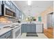 Open kitchen with stainless steel appliances and view to living area at 624 River Oaks Dr. # 52G, Myrtle Beach, SC 29579