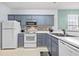 Well-equipped kitchen featuring gray cabinets and modern appliances at 624 River Oaks Dr. # 52G, Myrtle Beach, SC 29579