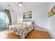 Bright bedroom with a comfortable bed and hardwood floors at 624 River Oaks Dr. # 52G, Myrtle Beach, SC 29579