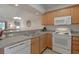 Galley kitchen with light wood cabinets, white appliances, and granite countertops at 146 Scotch Broom Dr. # P-204, Little River, SC 29566