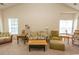 Spacious living room features a vaulted ceiling, comfy seating, and ample natural light at 5810 Longwood Dr. # 14-304, Murrells Inlet, SC 29576