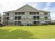 Condo building exterior showcasing multiple screened porches at 5810 Longwood Dr. # 14-304, Murrells Inlet, SC 29576