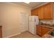 White appliances and light wood cabinets in this galley kitchen at 5810 Longwood Dr. # 14-304, Murrells Inlet, SC 29576