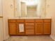Double vanity bathroom with light wood cabinets and a large mirror at 5810 Longwood Dr. # 14-304, Murrells Inlet, SC 29576