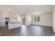 Open kitchen with island, granite countertop, and gray cabinets at 580 Duvall St., Longs, SC 29568