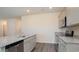 Gray kitchen cabinets, granite countertop, and stainless steel appliances at 580 Duvall St., Longs, SC 29568