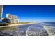 Stunning beachfront view with ocean waves, blue sky, and high rise buildings at 815 Hibernation Way, Conway, SC 29526