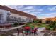 Relaxing community garden with brick patios, red chairs, and train mural at 815 Hibernation Way, Conway, SC 29526