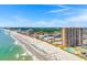 Aerial view of a coastal community with beach, high-rise buildings, and lush green areas at 9650 Shore Dr. # 902, Myrtle Beach, SC 29572