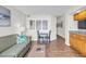 Open living area with sofa, small table, and kitchen view at 4800 S Ocean Blvd. # 319, North Myrtle Beach, SC 29582
