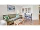 Small dining area with table and chairs adjacent to living room at 4800 S Ocean Blvd. # 319, North Myrtle Beach, SC 29582