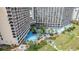 Aerial view of resort complex with multiple pools, palm trees, and surrounding buildings at 4800 S Ocean Blvd. # 319, North Myrtle Beach, SC 29582
