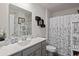 Clean bathroom with a shower/tub combo and floral accents at 805 Woodland Farms Circle, Aynor, SC 29511