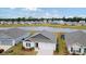 Aerial view of the house and surrounding neighborhood with a pond at 805 Woodland Farms Circle, Aynor, SC 29511