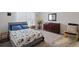Bright bedroom with floral bedding, dresser, and comfortable seating area at 805 Woodland Farms Circle, Aynor, SC 29511