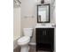 Clean bathroom with dark vanity, glass shelf, and tiled floor at 1517 Schooner Ct., Garden City Beach, SC 29576