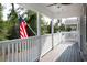 A large porch with a wooden floor and white railing at 1517 Schooner Ct., Garden City Beach, SC 29576