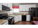 Modern kitchen featuring white shaker cabinets, granite countertops, and black appliances at 1517 Schooner Ct., Garden City Beach, SC 29576