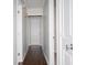 Long hallway with dark hardwood flooring and neutral-colored walls at 1517 Schooner Ct., Garden City Beach, SC 29576