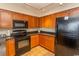 Kitchen features black appliances and wood cabinets at 1321 S Ocean Blvd. # 905, North Myrtle Beach, SC 29582