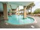 Resort-style pool with surrounding lounge chairs and palm trees at 1321 S Ocean Blvd. # 905, North Myrtle Beach, SC 29582