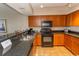 Well-equipped kitchen with granite countertops and wood cabinets at 1321 S Ocean Blvd. # 905, North Myrtle Beach, SC 29582