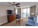 Living room features ocean view and flat screen TV at 1321 S Ocean Blvd. # 905, North Myrtle Beach, SC 29582