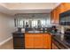 Kitchen with granite countertops, black appliances, and wood cabinets at 1321 S Ocean Blvd. # 905, North Myrtle Beach, SC 29582