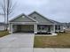 One-story house with attached garage, landscaping, and neutral exterior at 6220 Ellwood Rd., Galivants Ferry, SC 29544