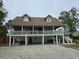 Two-story house with a large deck, ample parking, and a spacious yard at 710 Lakeside Dr., Surfside Beach, SC 29575