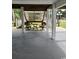 Covered patio area under the house with chairs and a table at 710 Lakeside Dr., Surfside Beach, SC 29575