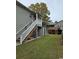 Back of house showing stairs, storage, and a grassy backyard at 710 Lakeside Dr., Surfside Beach, SC 29575