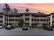 Exterior view of a condo building with parking and landscaping at 1551 Spinnaker Dr. # 5822, North Myrtle Beach, SC 29582