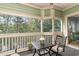 Screened porch with wooded views and a seating area at 1551 Spinnaker Dr. # 5822, North Myrtle Beach, SC 29582