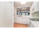 White kitchen cabinets, view into living room, and wood flooring at 1551 Spinnaker Dr. # 5822, North Myrtle Beach, SC 29582