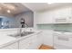 Kitchen with white cabinets, stainless steel appliances, and light green backsplash at 1551 Spinnaker Dr. # 5822, North Myrtle Beach, SC 29582