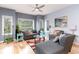 Living room features light wood floors, gray sofas, and large windows at 1551 Spinnaker Dr. # 5822, North Myrtle Beach, SC 29582